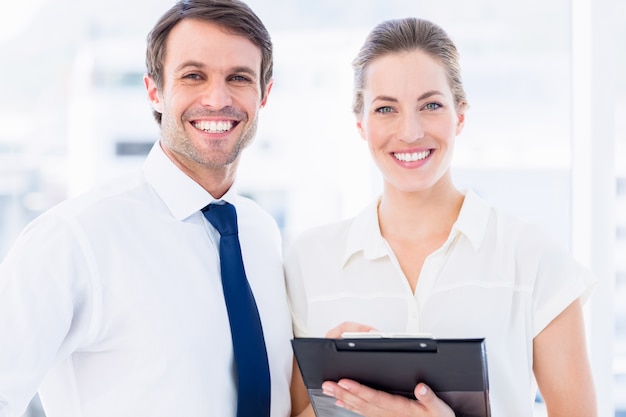 Smartly dressed colleagues using digital tablet