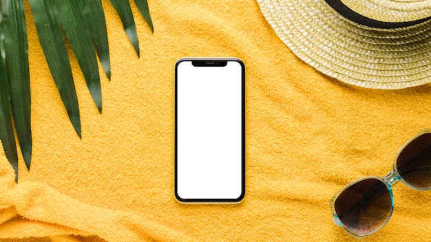 Photo smartphone and beachfront accessories on light background