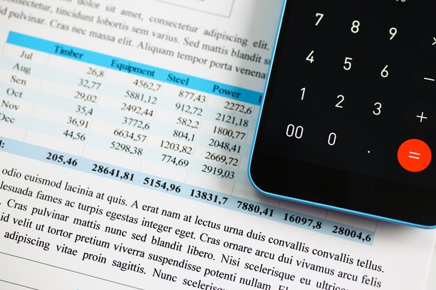 smartphone calculator and financial statistics on infographics