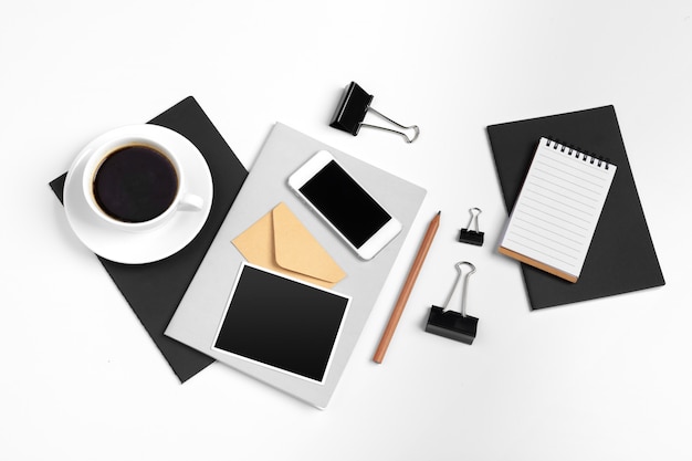 Smartphone and coffee cup, and office supplies