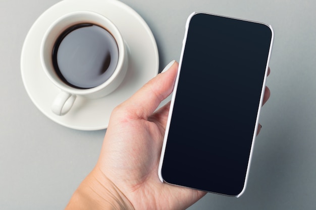 Smartphone and coffee on the table