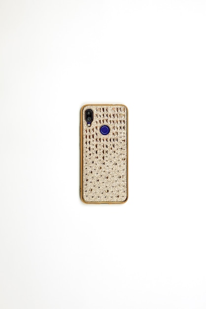 A smartphone in cover case decorated with golden stones