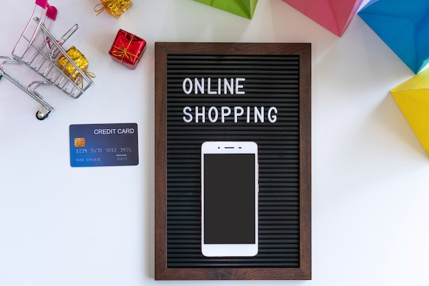 Smartphone and credit card on desk in online shopping and new normal concept