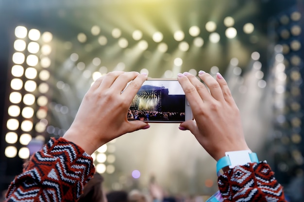 Smartphone over the crowd at a music concert. Record light show