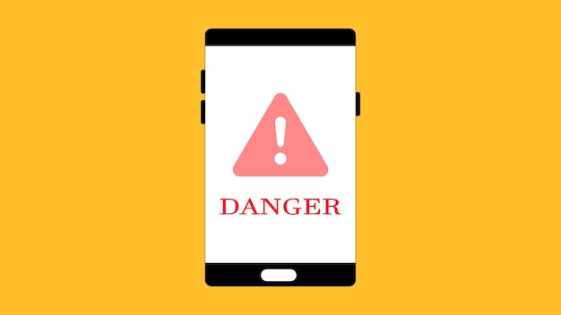 Photo smartphone displaying a warning sign with the word danger on its screen on a yellow background