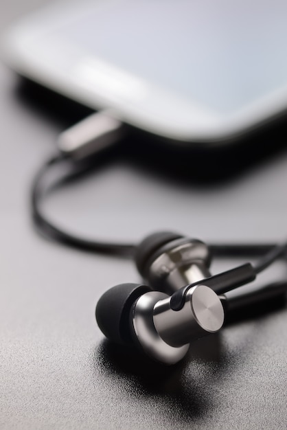 Smartphone and earphones on table