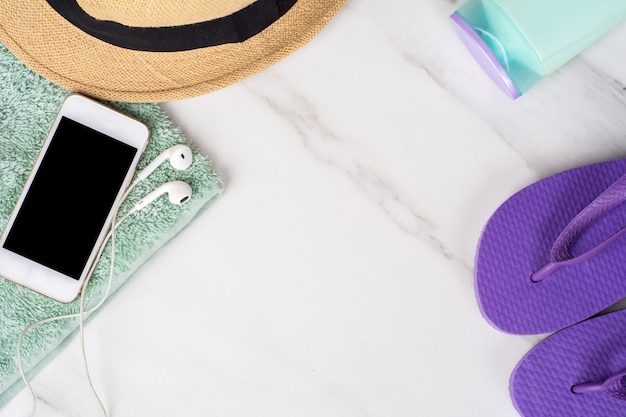 Smartphone, flip-flops, sunscreen and towel.