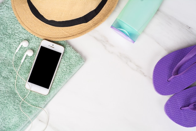 Smartphone, flip-flops, sunscreen and towel.