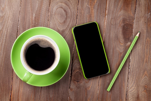 Smartphone and green coffee cup