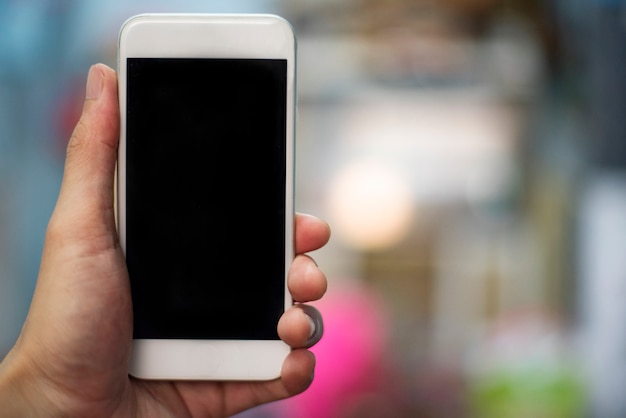 Smartphone hand - man hand holding the white smartphone with black screen - using mobile phone blank