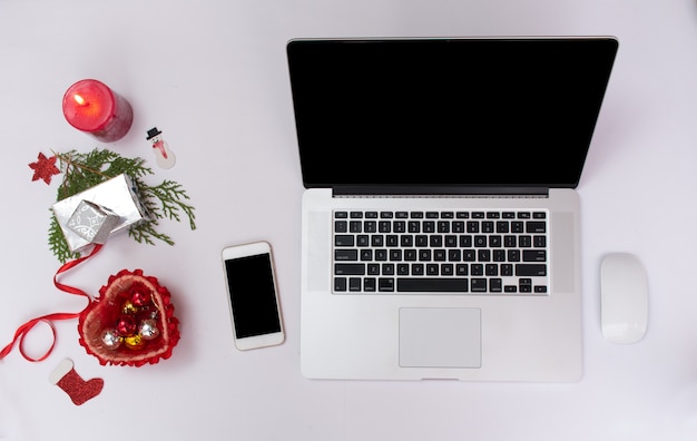 Smartphone and laptop with Christmas decoration