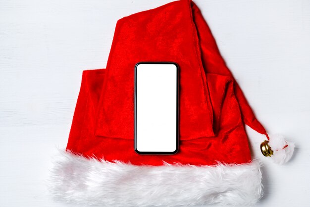 Smartphone op kerstman hoed