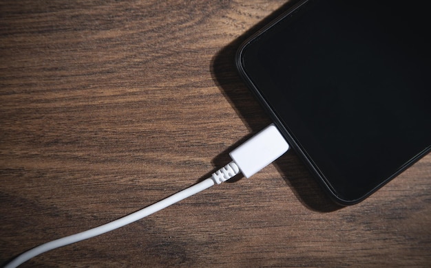 Smartphone opladen batterij op de houten tafel