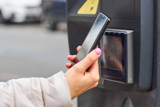 Photo smartphone payment with nfc technology for public parking with copy space. contactless payment concept.