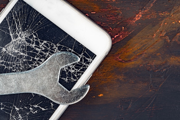 Smartphone repair concept, Damaged display of smartphone and tools