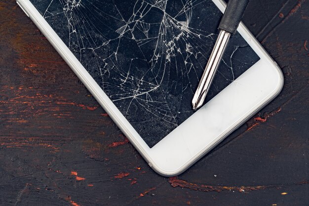 Smartphone repair . Damaged display of smartphone and tools