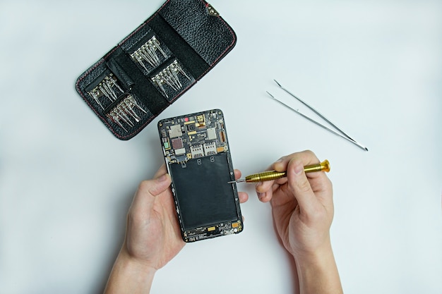 Smartphone repair. disassembled smartphone in male hands.
smartphone repair kit. flat lay, top view. space for text.