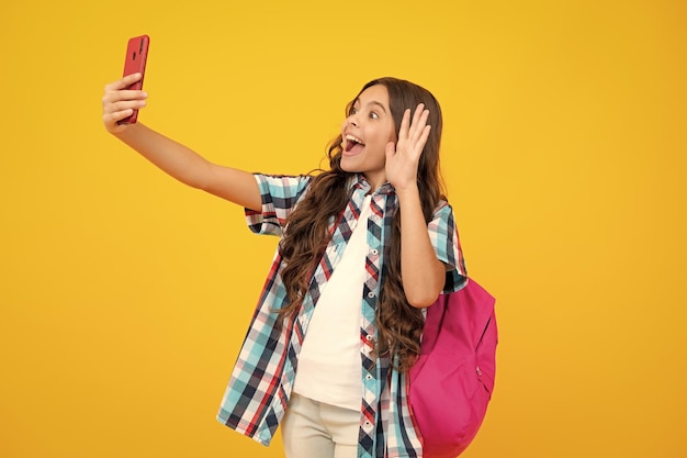 Smartphone and school child Student girl with phone on isolated background