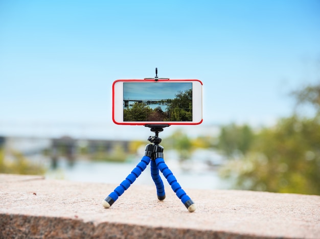 Smartphone stands on a tripod 