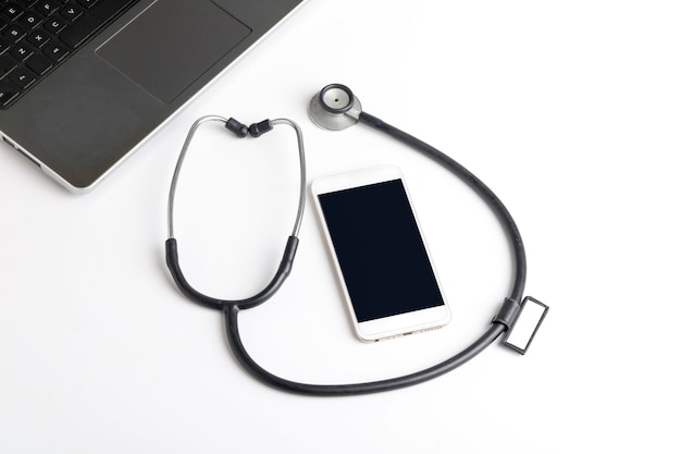 Smartphone and stethoscope on white background