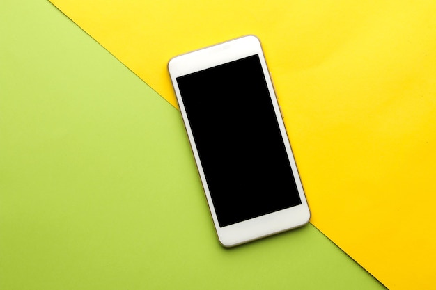 Smartphone. White phone on a bright multi-colored background. top view. space for text