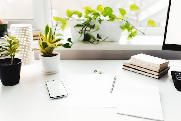 Photo smartphone on white table, work from home, office stuff. high quality photo