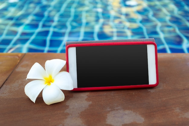 Smartphone with black screen near pool. Vacation 