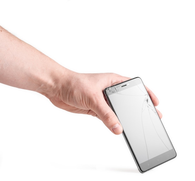 Smartphone with a broken screen in a man's hand  