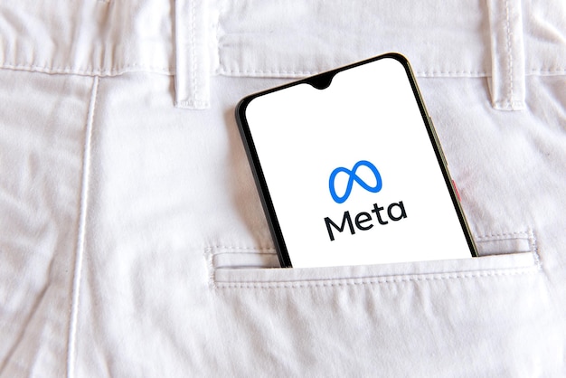 Smartphone with meta application in white jeans pocket