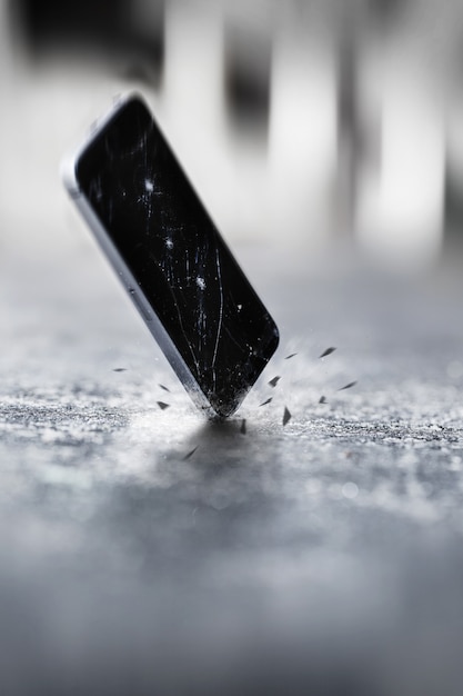 Photo smartphones falling and crashing on the ground in the road. accident with smartphone