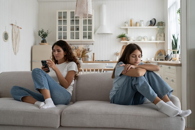 Smartphones and parenting gadget addicted mother using phone not paying attention to daughter