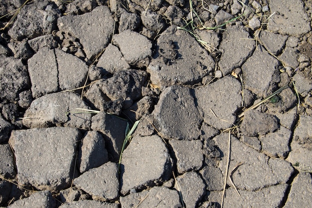 Smashed asphalt. Closeup of the broken road