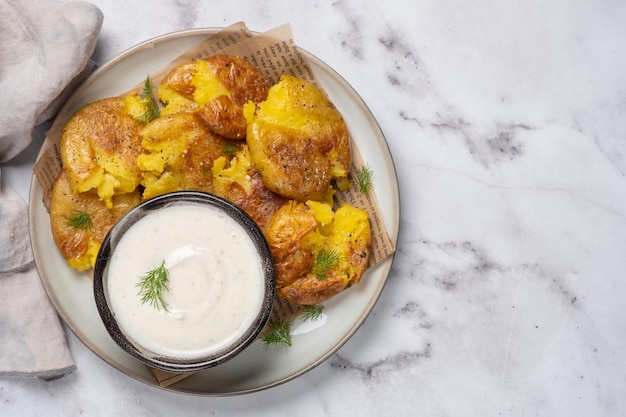 Smashed potato on parchment paper