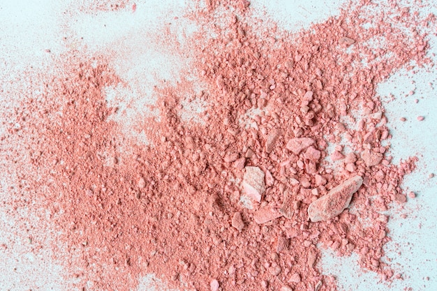 Smear of crushed orange blush on as sample of cosmetics product