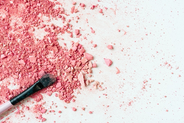 Smear of crushed pink blush on as sample of cosmetics product, copy space, top view