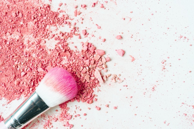 Smear of crushed pink blush on as sample of cosmetics product, copy space, top view	