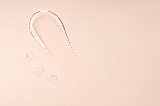 Smear of gel texture on beige background