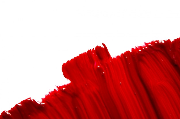 Photo smear and texture of red lipstick or acrylic paint background.