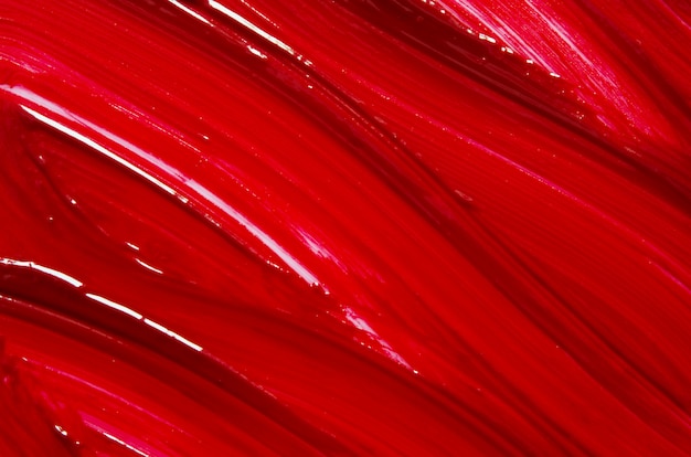 Smear and texture of red lipstick or acrylic paint background.