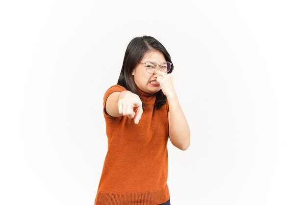 Photo smelling something stinky and disgusting of beautiful asian woman isolated on white background