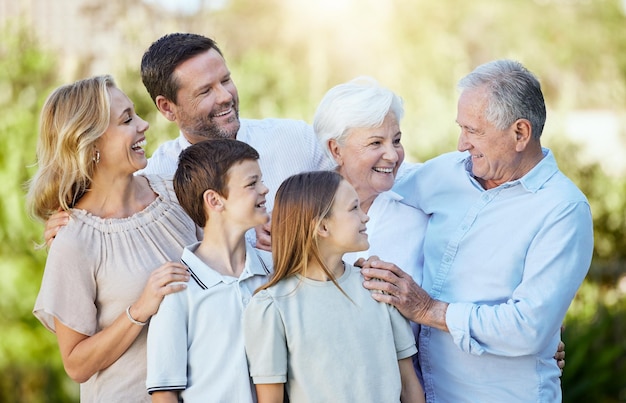 smile big family and generations outdoor on holiday together for funny conversation bonding and love happy mother father and children with grandparents people and siblings laughing in nature
