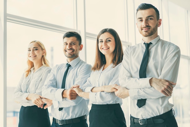 the smile business people hold hands