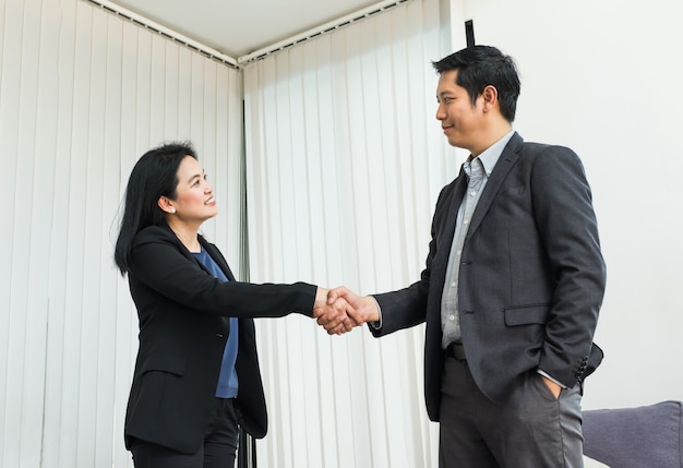 Smile Business woman and  business man shaking hand in office