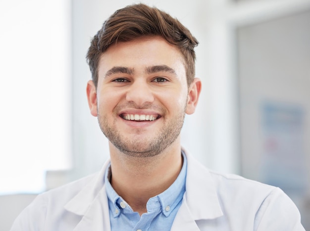 Smile doctor face and portrait of man in hospital with crossed arms for wellness medicine and medical care Healthcare insurance and happy health worker in clinic for consulting trust and support