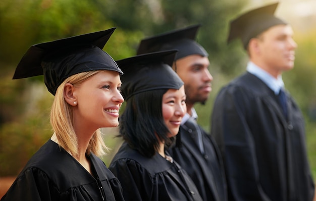 smile graduation and woman student in line with friends at outdoor ceremony for college or university education scholarship or achievement with graduate men and women at academic school event