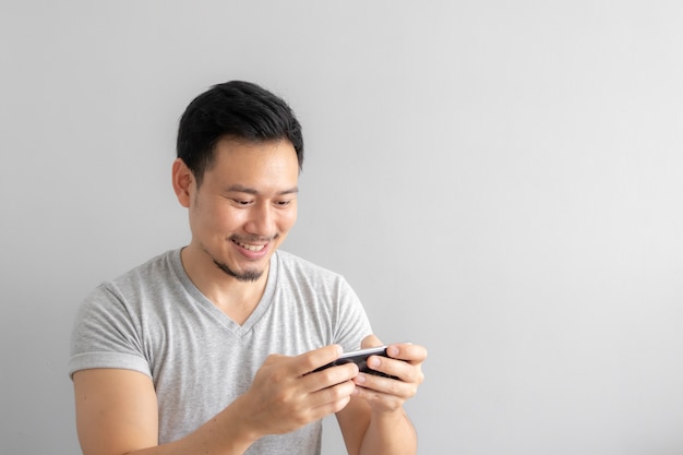 Smile and happy face of man playing mobile game.