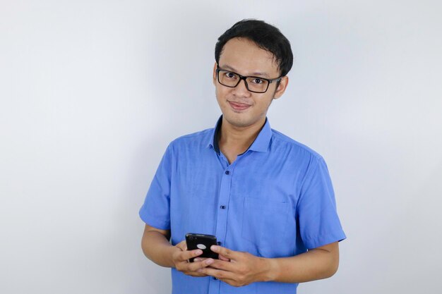 Smile and happy face of Young Asian man with phone in hand Advertising model concept with blue shirt