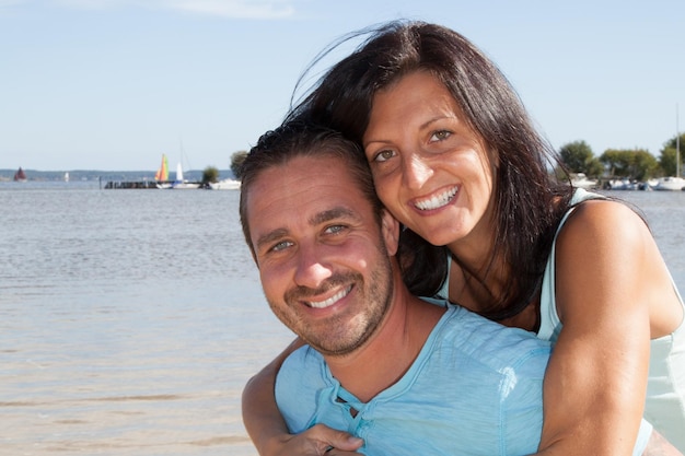 Smile and happy young man and woman couple in summer sea vacation