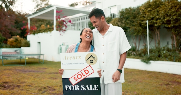 Photo smile hug and couple with sold sign new home and future property investment together love mortgage and real estate excited man and happy woman in garden at house with opportunity in neighborhood