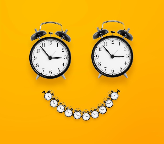 Smile look made from clocks on yellow background happy time concept